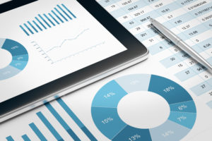 Tablet and Financial Report on Table